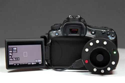 The Okii USB Follow Focus controller alongside a Canon DSLR for scale. Photo provided by Okii Systems LLC.