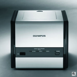 Olympus' P-11 photo printer. Courtesy of Olympus, with modifications by Michael R. Tomkins. Click for a bigger picture!