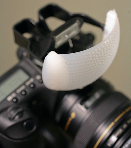 Gary Fong Puffer pop-up flash diffuser, mounted on a Canon DSLR. Photo provided by Gary Fong Inc. Click for a bigger picture!