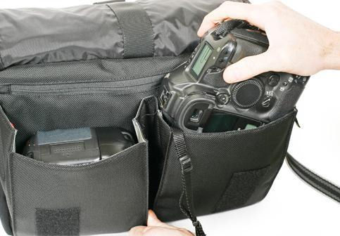 Canon digital SLR being placed in the Urban Disguise 70 Pro shoulder bag. Photo provided by Think Tank Photo LLC. Click for a bigger picture!