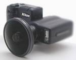 Nikon's Coolpix 990 digital camera with fisheye converter lens attached.  Copyright (c) 2001, The Imaging Resource. All rights reserved.