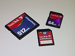 Sandisk 512MB CompactFlash card, 64MB SD card and 32MB MultiMediaCard. Copyright (c) 2001, Michael R. Tomkins, all rights reserved. 
