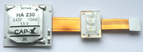 This supercapacitor-powered LED flash module reference design, developed by Seoul Semiconductor, uses a thin, prismatic HA230 CAP-XX supercapacitor and an AnalogicTech AAT1282 LED flash driver (on reverse side) to drive high-current Seoul Semiconductor LEDs. Photo and caption provided by CAP-XX Ltd. Click for a bigger picture!
