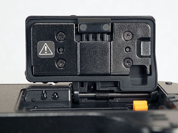 Canon EOS R Review -- close-up of battery compartment door showing latch slider and gasket.