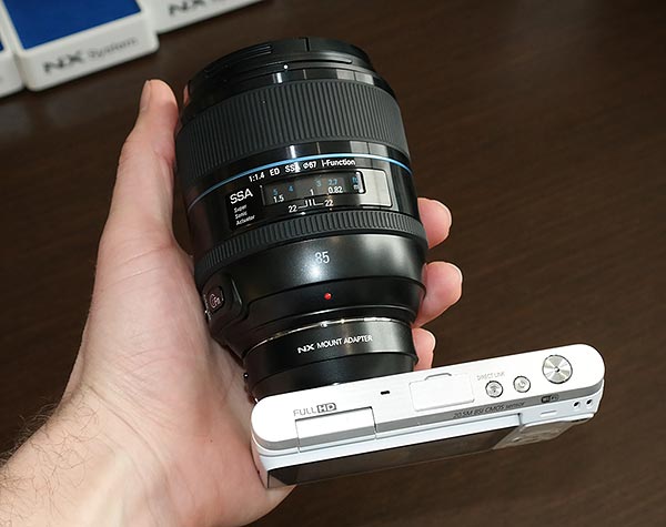 Samsung NX Mini Review -- in hand with 85mm NX lens and adapter