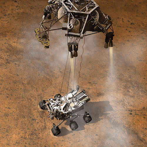 Curiosity's arrival on Mars was unconventional. In a so-called 'sky crane' landing, the rover was lowered on cables beneath the rocket-powered landing stage. Rendering provided by NASA/JPL-Caltech. Click for a bigger picture!