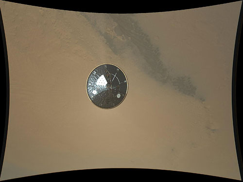 The first public high-res image from the MARDI camera shows the Curiosity rover's heat shield falling away, some three seconds after separation. Photo provided by NASA/JPL-Caltech/MSSS. Click for a bigger picture!