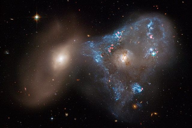 A pair of galaxies collide to form a brilliant ‘space triangle’ in a new Hubble Space Telescope image